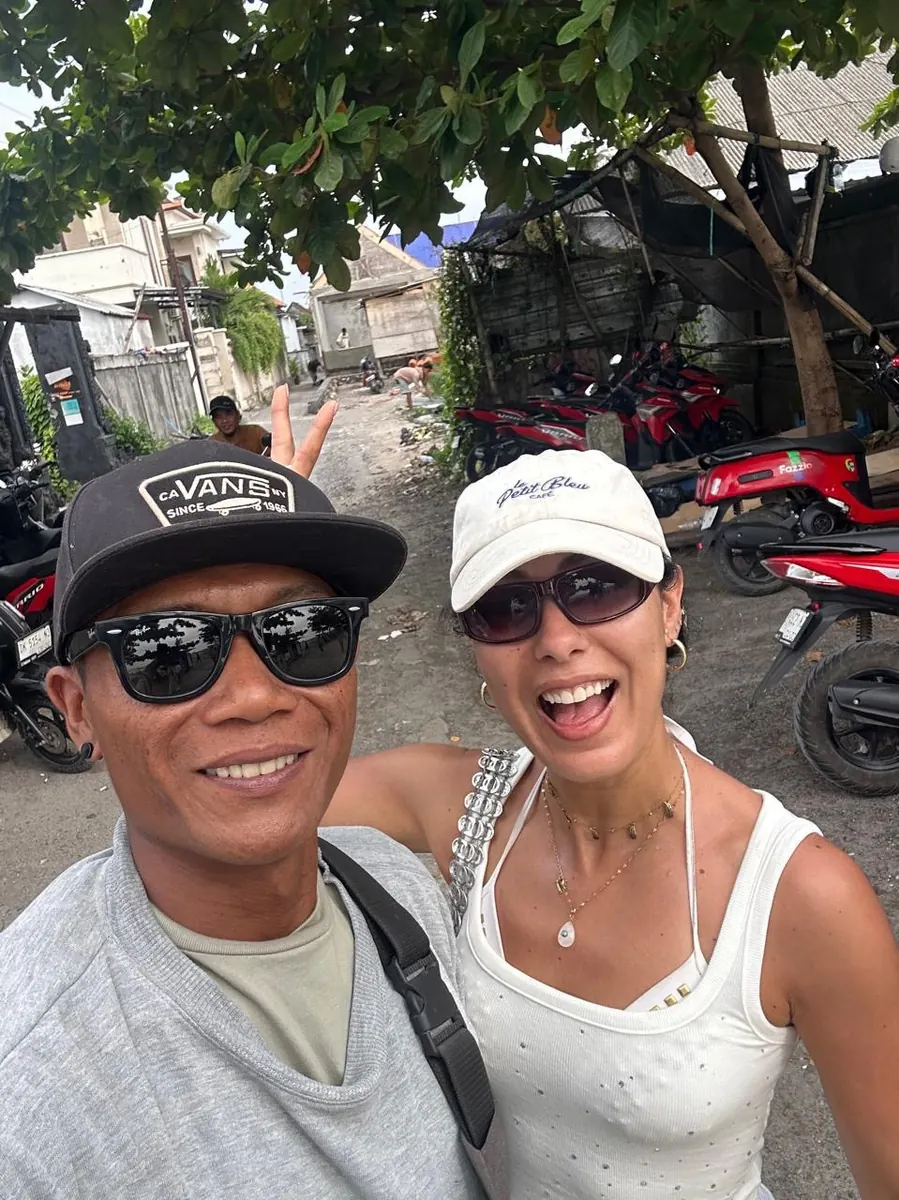 Gede with a guest in a village street on Nusa Penida